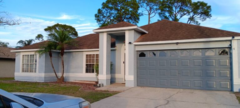 Exterior house painting project with new gray paint and white trim by Level Up