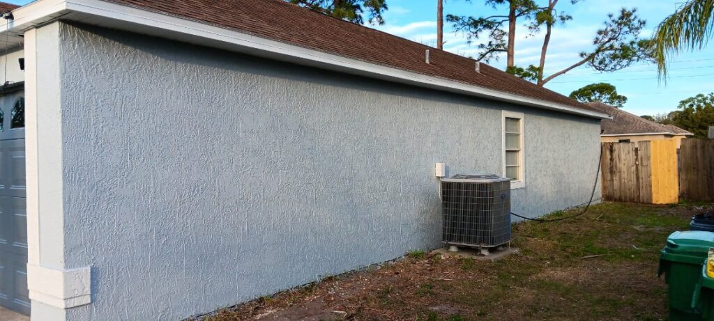 Newly painted stucco side wall of a Brevard County home