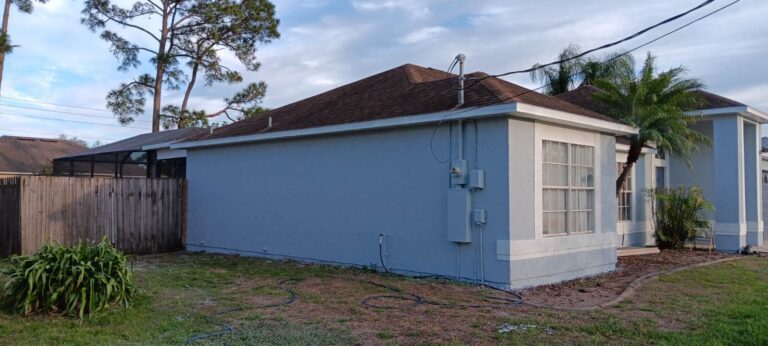 Exterior painting on the side of a home in Brevard County by Level Up Landscaping & Home Services